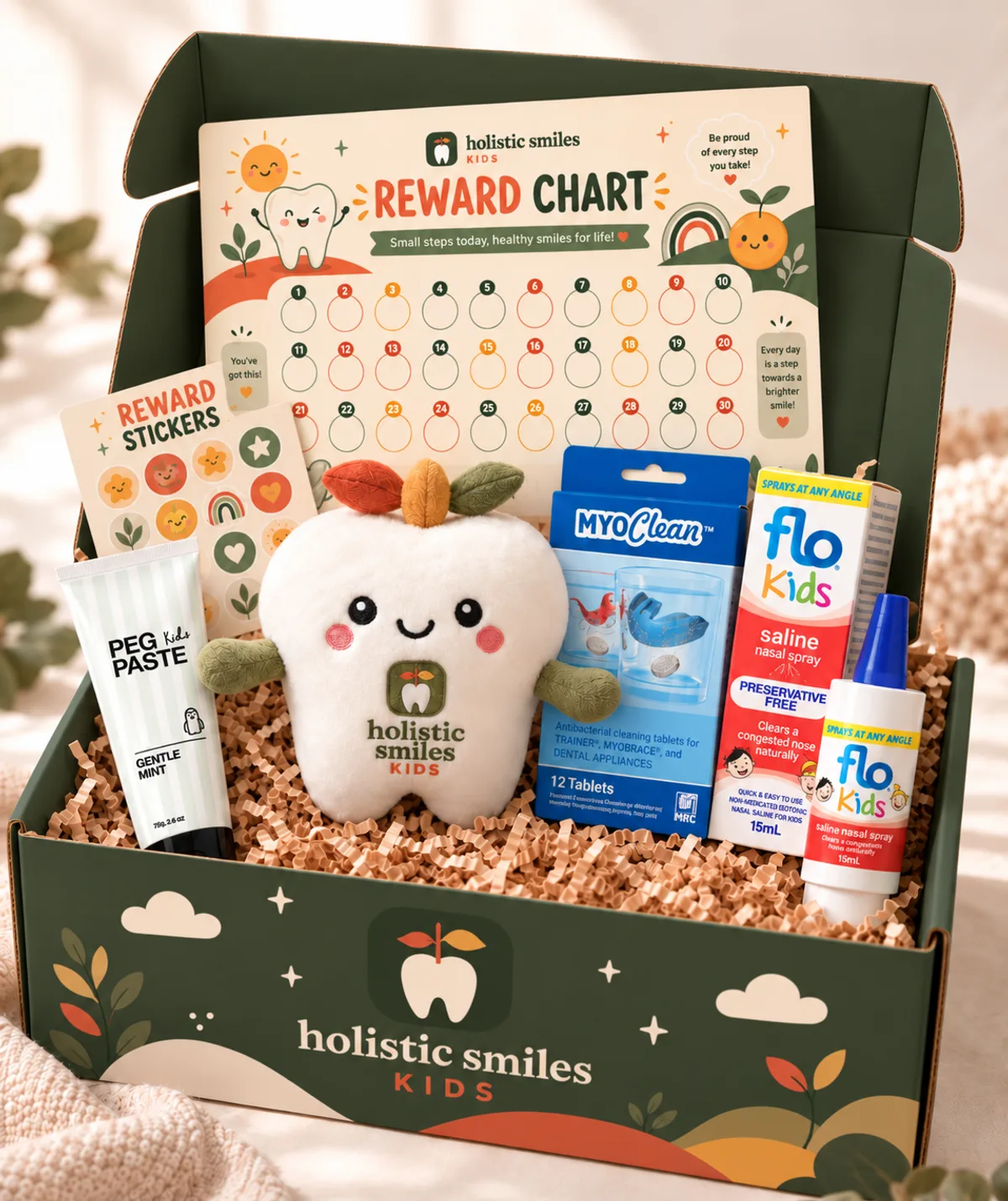The quarterly refill box, open: a reward chart and stickers, toothpaste, appliance cleaning tablets, a saline nasal spray and a plush Sprout tooth